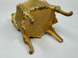a gold plate with a horse on it on a stand