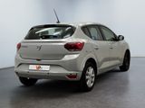 the rear view of a silver car parked in a white room