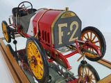 a model of a red and yellow car on display
