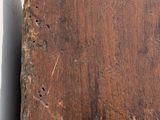 a piece of wood that has been scratched off and is sitting on a table