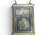 a metal clock that is hanging on the wall