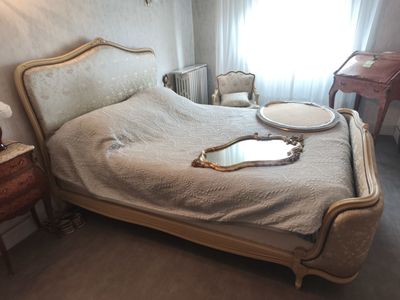 a bed with a mirror on it in a room