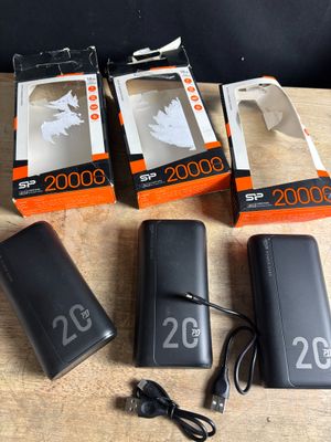 three boxes of batteries and a charger sitting on a table