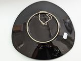 a black plate with a gold ring on top of it