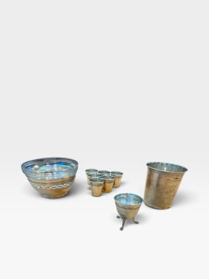a group of four bowls and cups sitting on top of a white surface