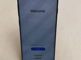 the back of a black phone with a welcome screen on it