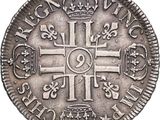 a silver coin with a cross and crown on it
