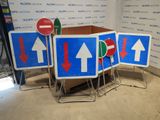four signs with arrows on them in a room