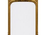 a gold framed mirror on a white wall with a white background