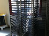 many trays of food on the rack in the room