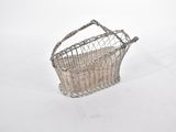 a small metal basket sitting on top of a snow covered ground