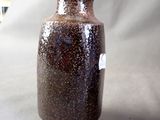 a brown vase that is sitting on a table