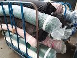 a lot of clothes on a cart outside of a building
