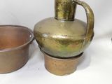 two pots and a bowl on a white surface