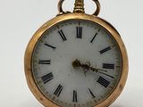 une montre de poche en or avec des chiffres romains sur le cadran