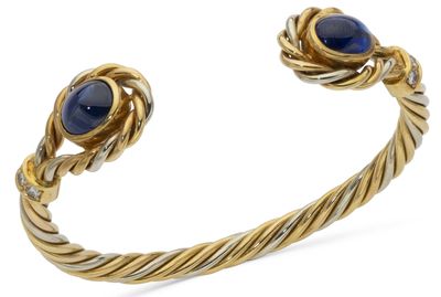 a close up of a bracelet with two blue stones on it