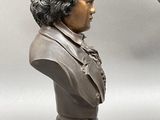 two busts of men with different hair styles on them