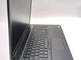 a laptop computer sitting on a table with a keyboard