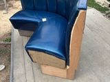 a blue leather chair and a wooden bench in a yard
