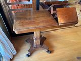 a wooden table with a leather bag on top of it