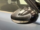 a car with a mirror that has a denting on it