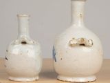 two vases that are sitting on a table