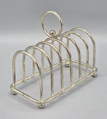 a silver plated toaster that has four slices of bread in it