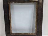 an old wooden frame with a label on it