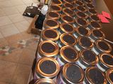 many jars of food sitting on a table in a restaurant