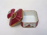 a small box with a lid that has a picture on it