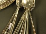 a lot of silver spoons and spoon spoons on a table