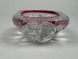 a pink glass candle holder with a heart design on it