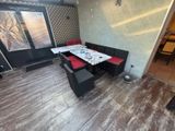 a table and chairs in the corner of a room