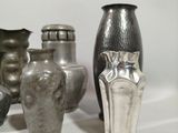 a lot of vases that are sitting on a table