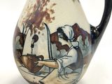 a small vase with a painting on it on a white surface