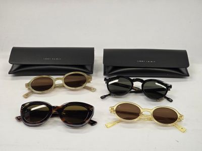 three pairs of sunglasses and a case on a table