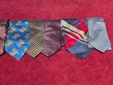 several ties laid out on a red carpet with a red background