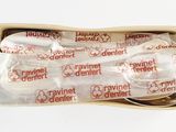 two spoons in a box that have been wrapped in plastic