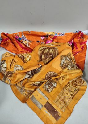 many different types of scarves laid out on a table