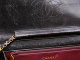 a black and red purse with a chain hanging from it
