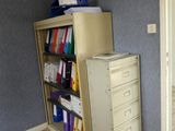 a refrigerator and a filing cabinet in a room with blue walls