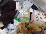 a pile of clothes and other items in a suitcase