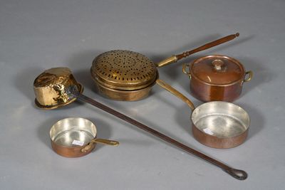 many different types of pots and pans sitting on a table