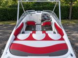 a boat with a red and white seat cover on it