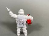 a small toy man holding a can of soda in his hand
