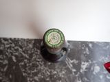 a bottle of wine sitting on a counter top
