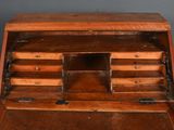 a small wooden desk with a drawer on top of it