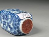 chinese blue and white porcelain bottle with a red lid