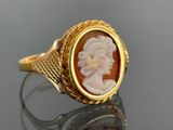 an image of a gold ring with a carved cameo of a woman