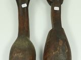 pair of antique wooden spoons on a white surface